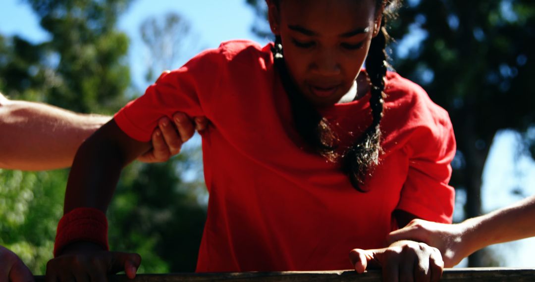 Young Girl Overcoming Obstacle Course with Help - Free Images, Stock Photos and Pictures on Pikwizard.com