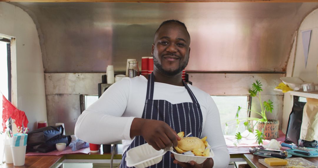 Smiling Food Truck Chef Serving Fresh Fries - Free Images, Stock Photos and Pictures on Pikwizard.com