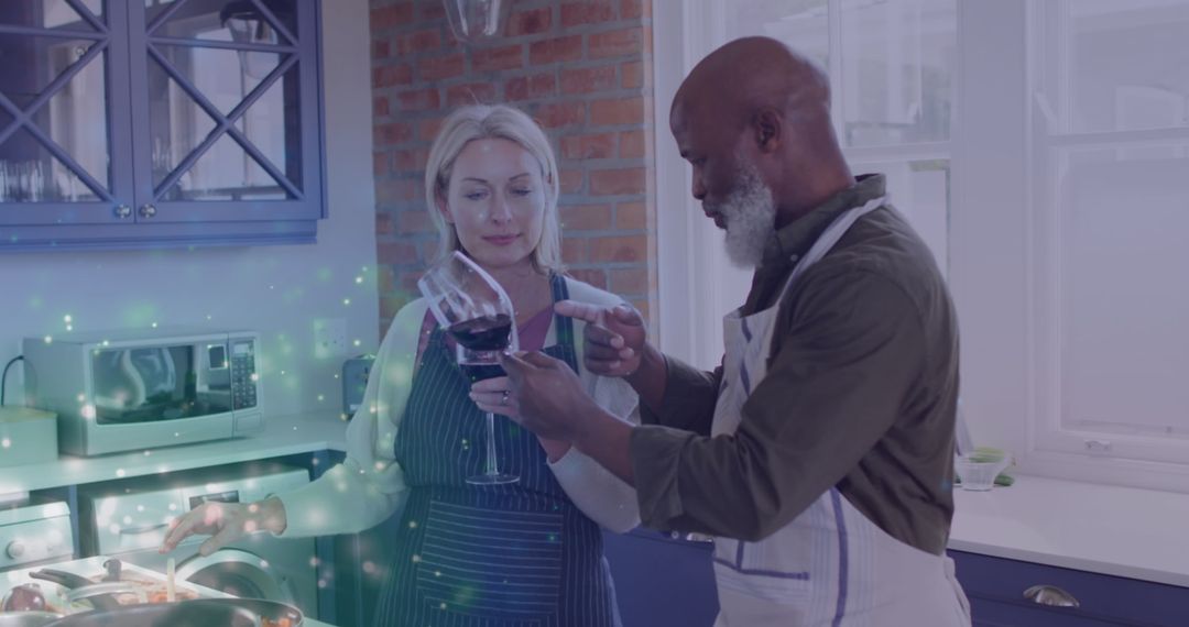 Diverse Senior Couple Enjoying Wine Together in Kitchen