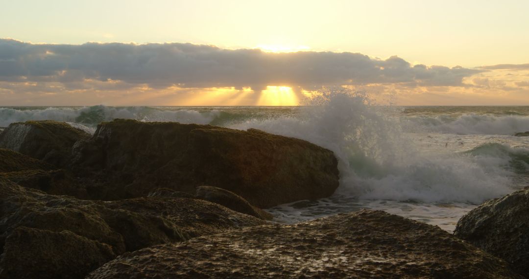 Dramatic Sunset Over Ocean Waves Crashing Against Rocks - Free Images, Stock Photos and Pictures on Pikwizard.com