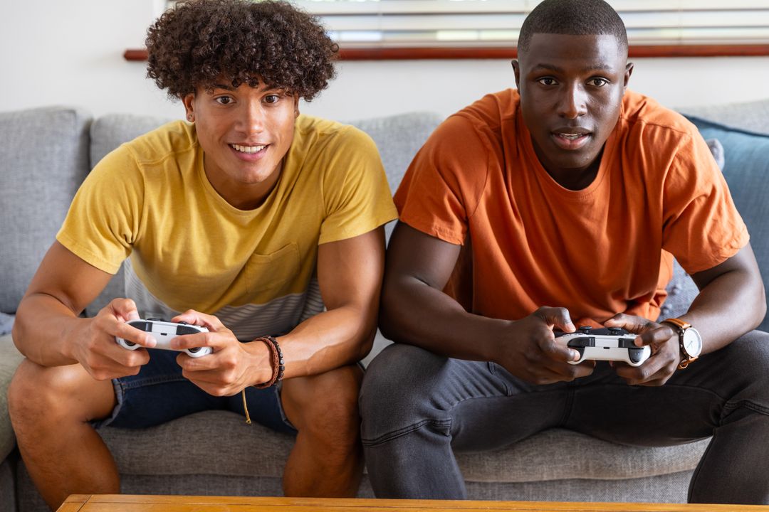 Two Young Diverse Men Playing Video Games at Home