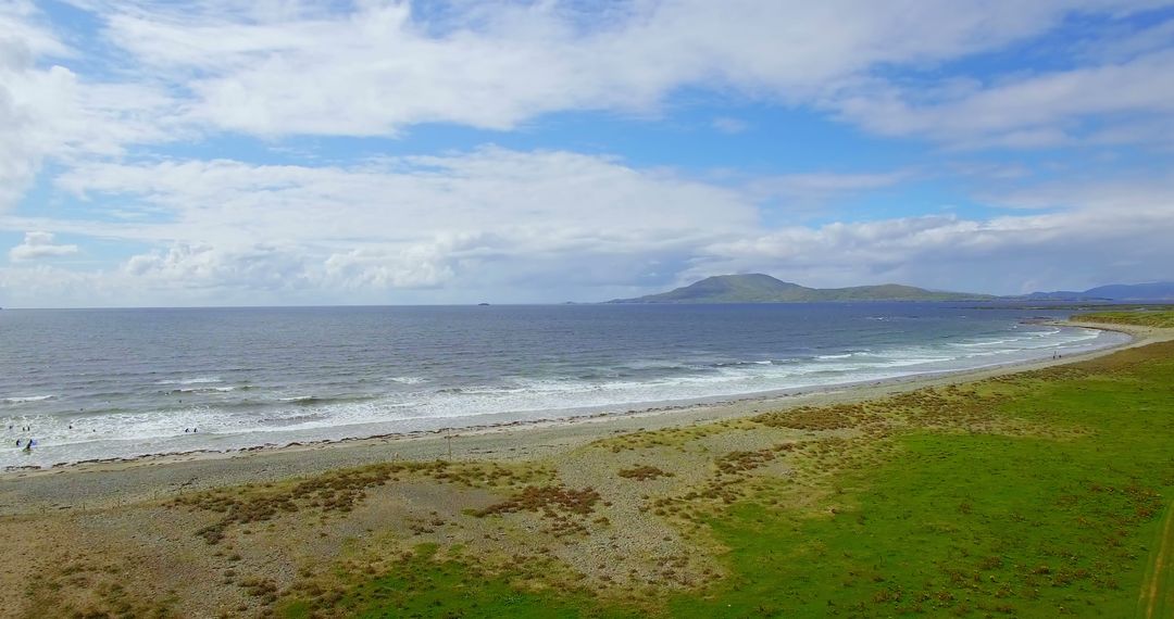 Scenic Coastline with Rolling Hills and Ocean Waves Under Clear Blue Sky - Free Images, Stock Photos and Pictures on Pikwizard.com