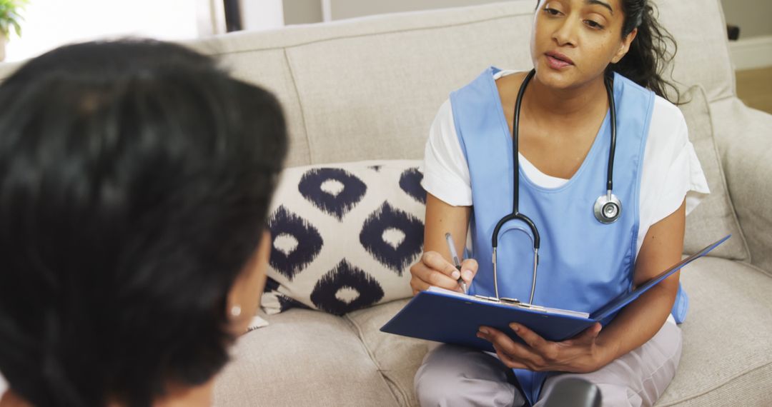 Healthcare Worker Consulting with Patient in Home Setting - Free Images, Stock Photos and Pictures on Pikwizard.com