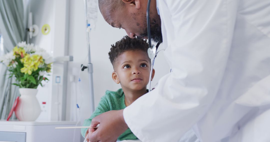 African american male doctor examining child patient at hospital - Free Images, Stock Photos and Pictures on Pikwizard.com