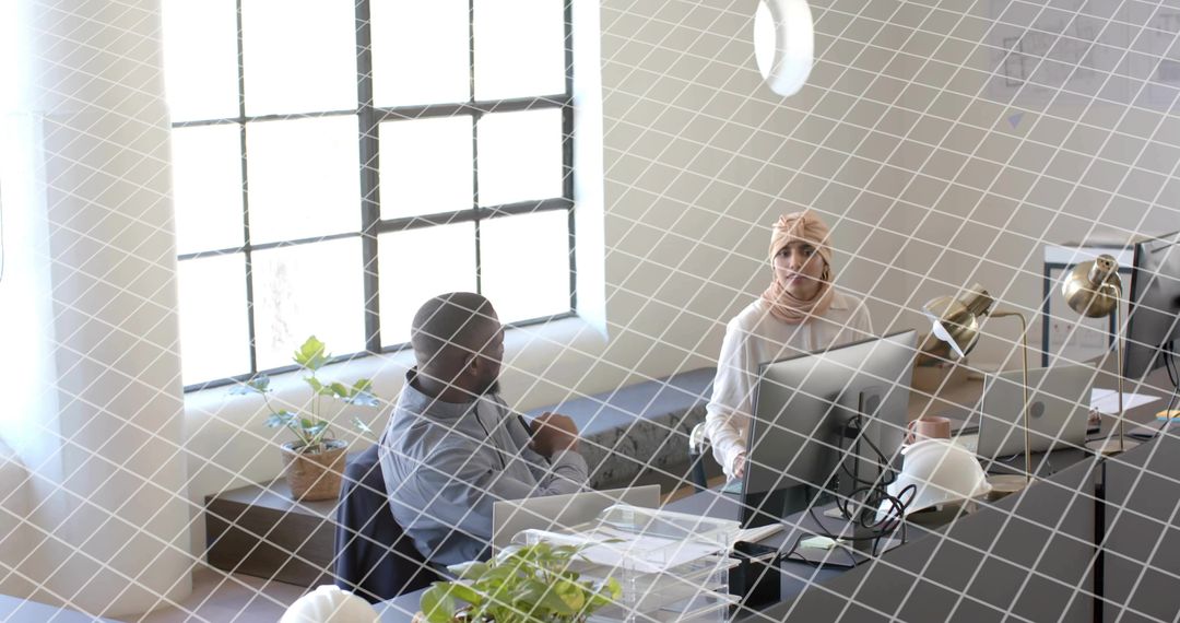 Diverse Team Collaborating in Bright Modern Office with Computers