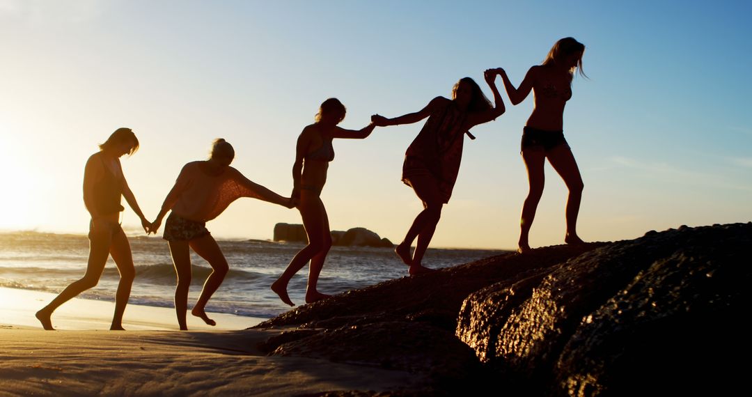 Group Of Friends Exploring Rocky Beach At Sunset - Free Images, Stock Photos and Pictures on Pikwizard.com