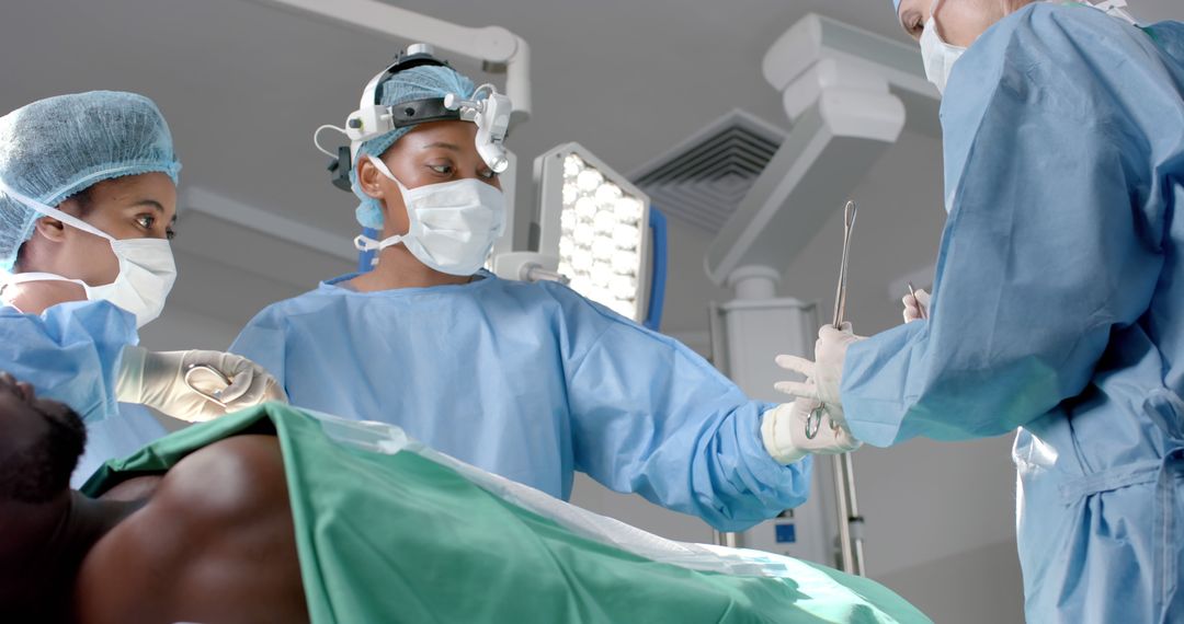 Surgical Team in Operating Room Performing Procedure - Free Images, Stock Photos and Pictures on Pikwizard.com