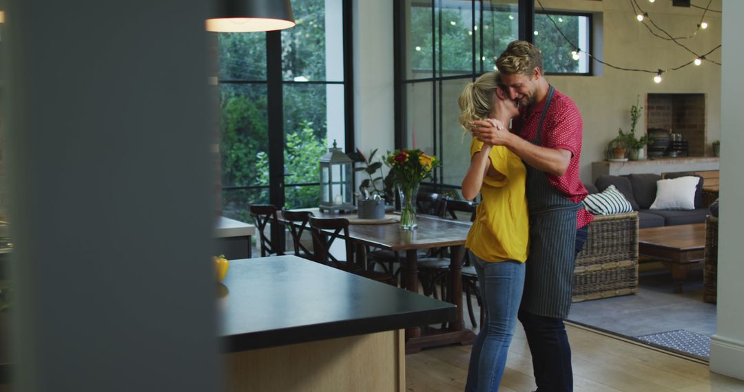 Happy Couple Embracing in Modern Kitchen with Cozy Lighting - Free Images, Stock Photos and Pictures on Pikwizard.com