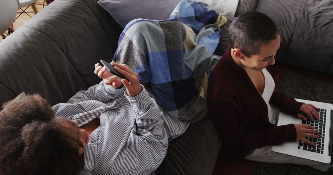 Couple Enjoying Technology in Casual Living Room Setting