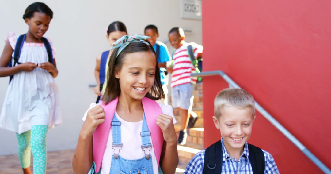 Joyful School Kids Walking on Staircase with Backpacks