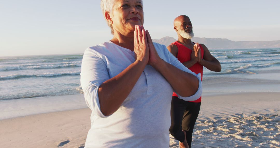 Senior african american couple practising yoga at the beach - Free Images, Stock Photos and Pictures on Pikwizard.com