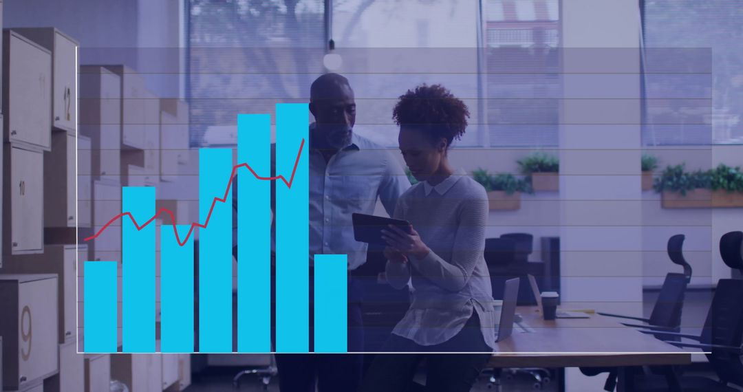 Business Team Analyzing Graph on Digital Tablet in Office