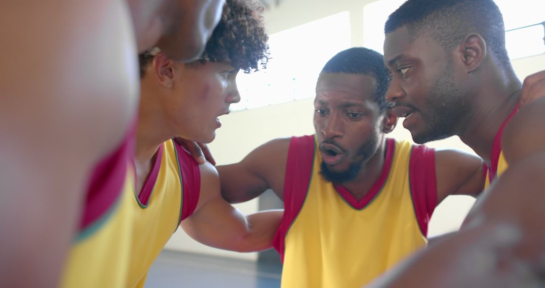 Focused Basketball Team Strategizes in Game Break Huddle