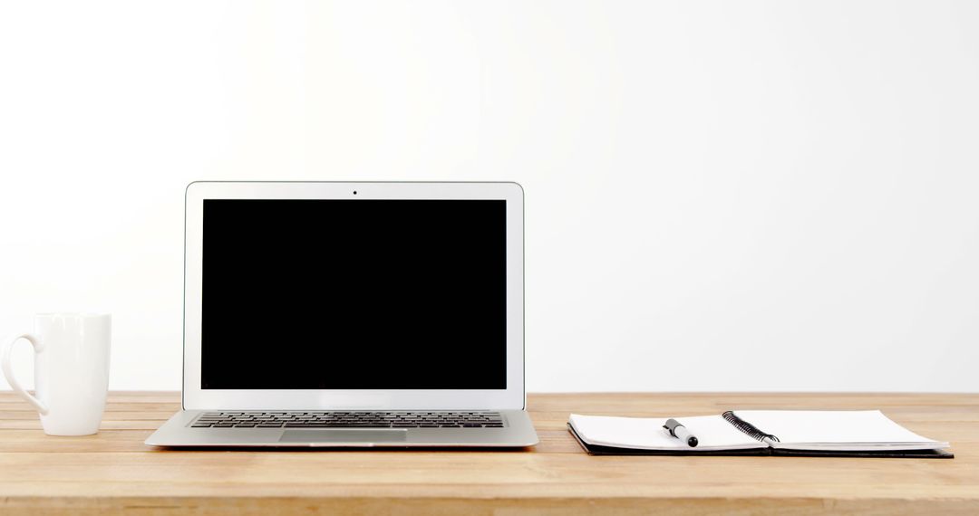 Minimalist Workspace with Laptop, Notebook, and Coffee Mug on Wooden Desk - Free Images, Stock Photos and Pictures on Pikwizard.com