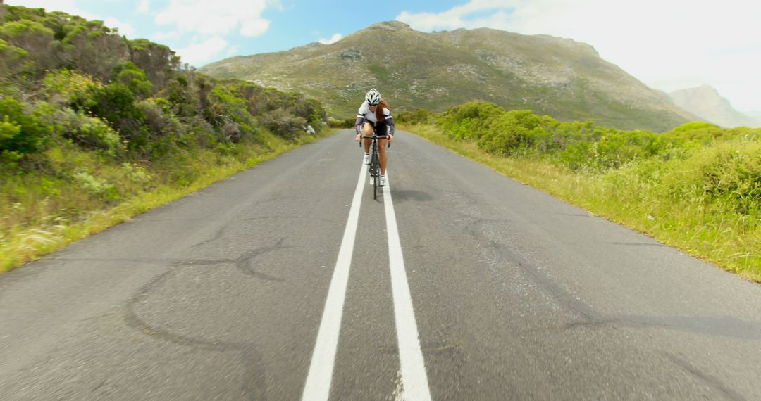 Cyclist Riding on Empty Mountain Road with Scenic View - Free Images, Stock Photos and Pictures on Pikwizard.com