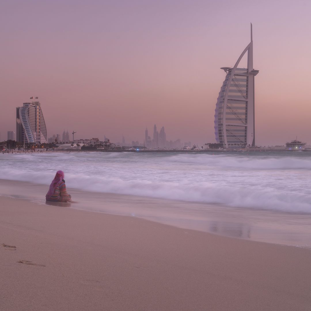 Solitary Moment on Dubai Beach at Sunset - Free Images, Stock Photos and Pictures on Pikwizard.com