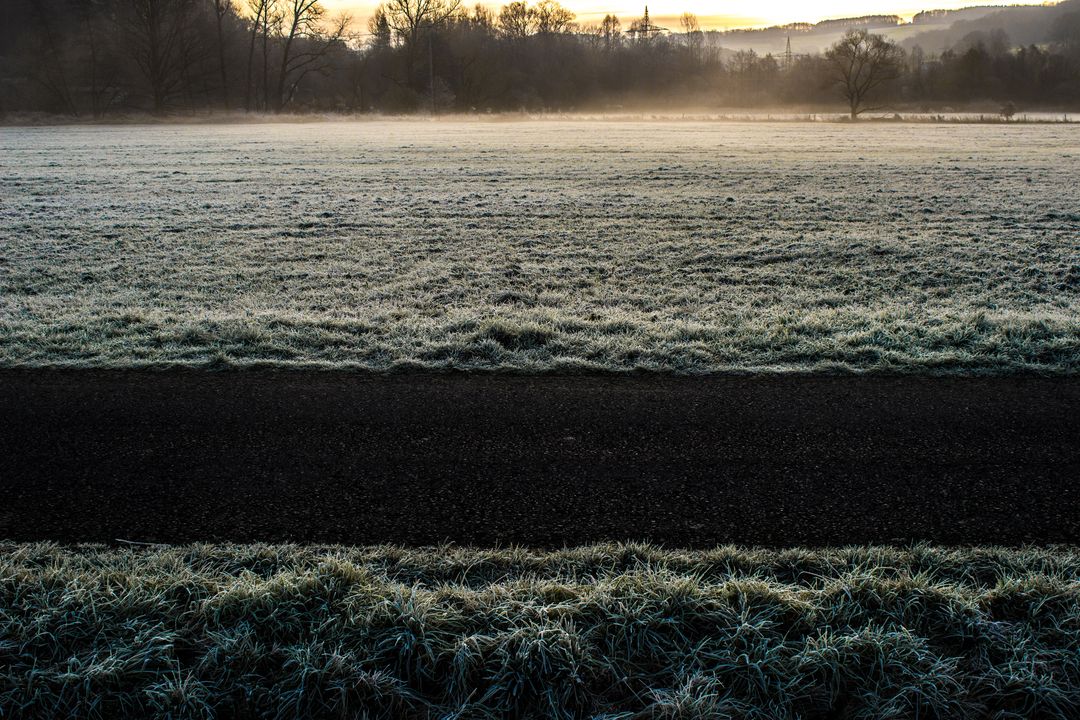 Frosty Field at Dawn with Misty Horizon and Rising Sun - Free Images, Stock Photos and Pictures on Pikwizard.com