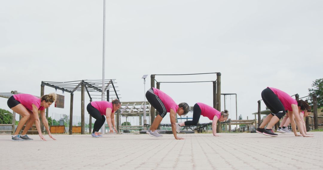 Group of Women Exercising Outdoors Performing Burpees - Free Images, Stock Photos and Pictures on Pikwizard.com