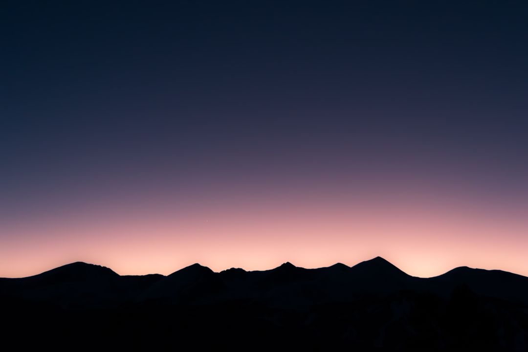 Silhouettes of Mountains at Twilight Against Colorful Gradient Sky - Free Images, Stock Photos and Pictures on Pikwizard.com