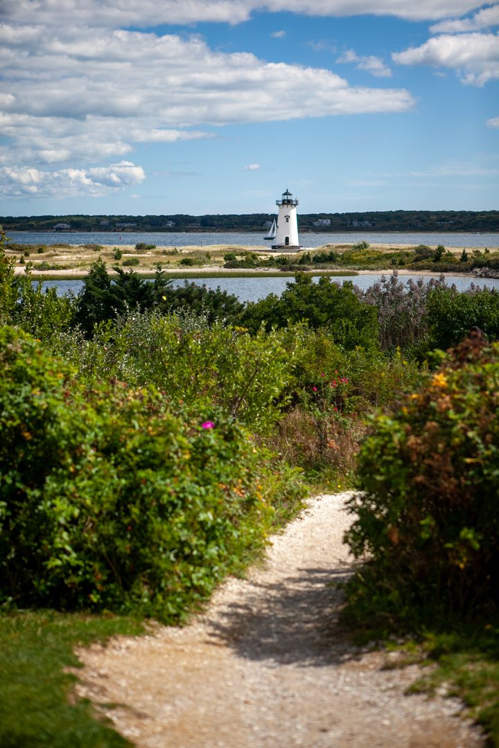 Scenic Coastal Pathway Leading to Majestic Lighthouse