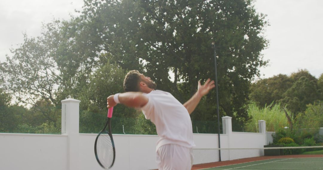 Male Tennis Player Preparing Serve on Outdoor Court - Free Images, Stock Photos and Pictures on Pikwizard.com