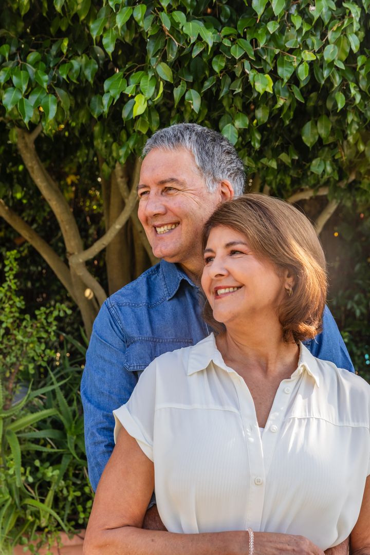 Happy Senior Couple Embracing in Lush Garden Setting