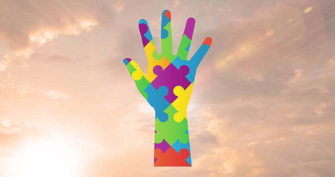 Multicolor Puzzle Hand Against Cloudy Sky