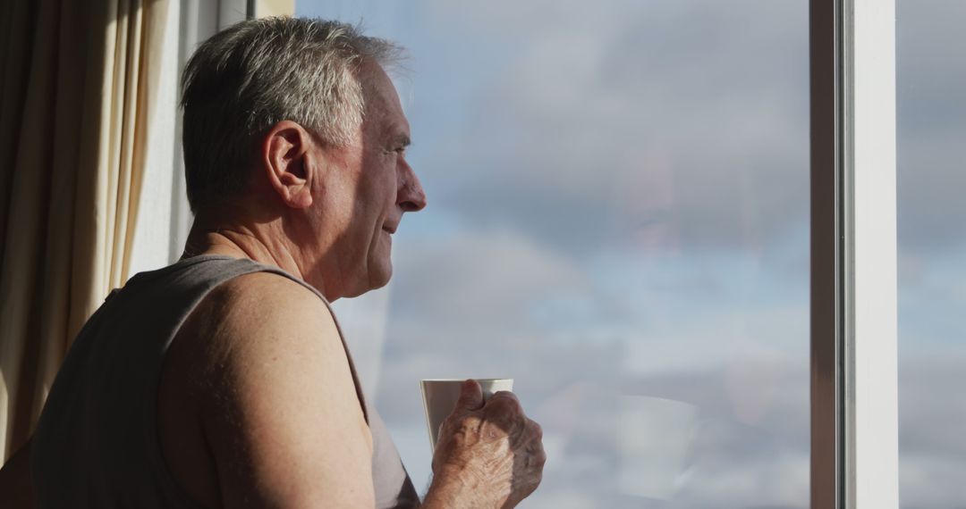 Senior Man Peacefully Drinking Coffee by Window - Free Images, Stock Photos and Pictures on Pikwizard.com