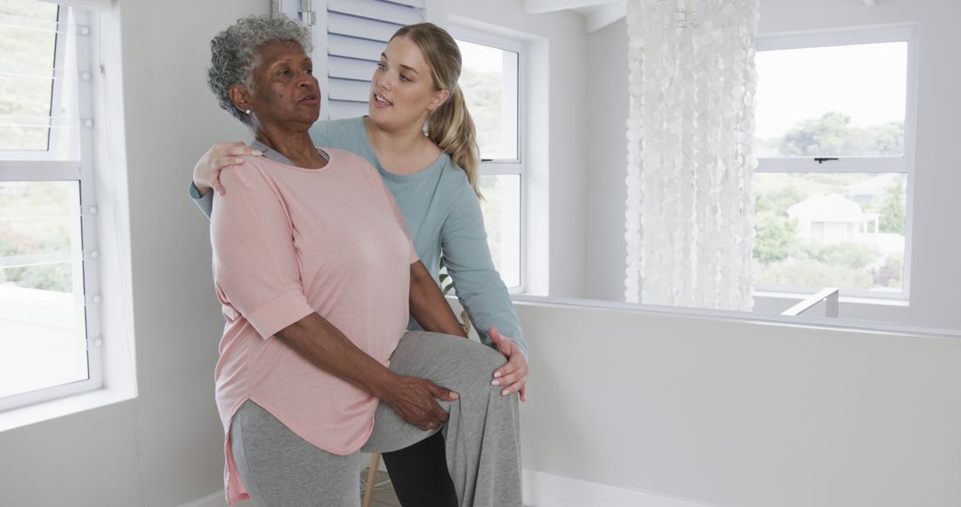 Physiotherapist Assisting Elderly Woman with Exercise at Home - Free Images, Stock Photos and Pictures on Pikwizard.com