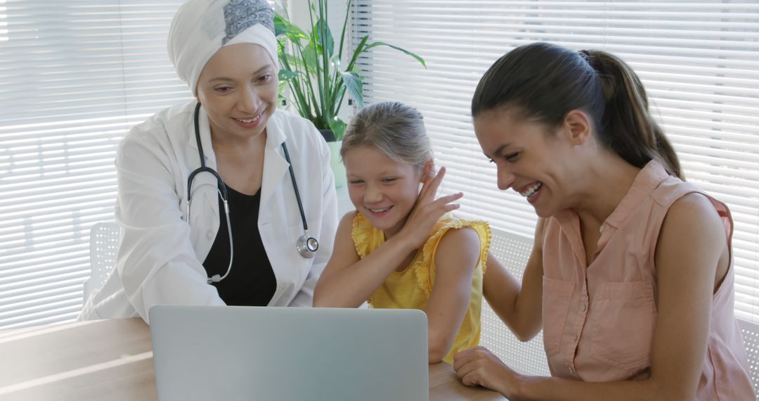 Doctor Interacting with Happy Family During Consultation - Free Images, Stock Photos and Pictures on Pikwizard.com