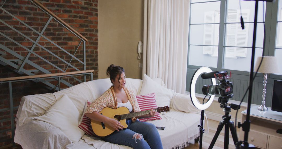 Female musician recording acoustic guitar song in home studio - Free Images, Stock Photos and Pictures on Pikwizard.com