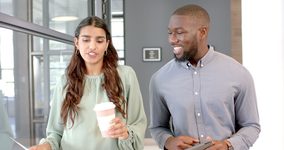 Colleagues Collaborating in Modern Office, Holding Coffee and Tablet