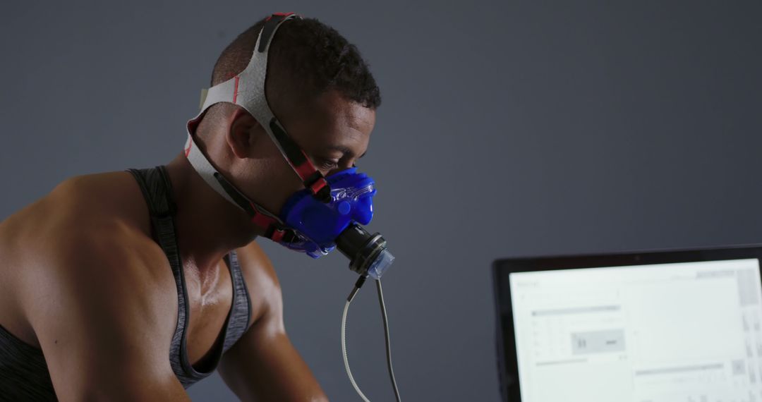 Male Athlete Doing VO2 Max Test with Respiratory Mask in Laboratory - Free Images, Stock Photos and Pictures on Pikwizard.com