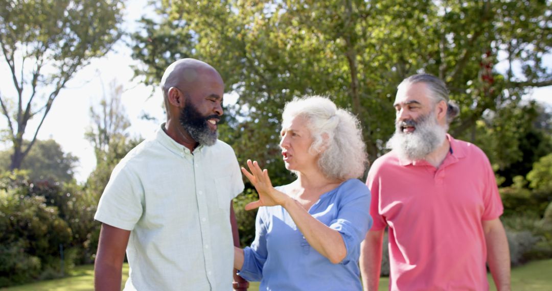 Senior Friends Strolling in Sunny Park Having Spirited Conversation