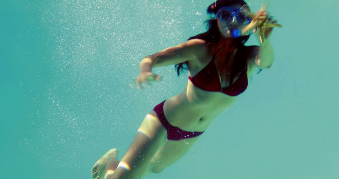 Woman Diving Underwater in Bikini with Goggles - Free Images, Stock Photos and Pictures on Pikwizard.com