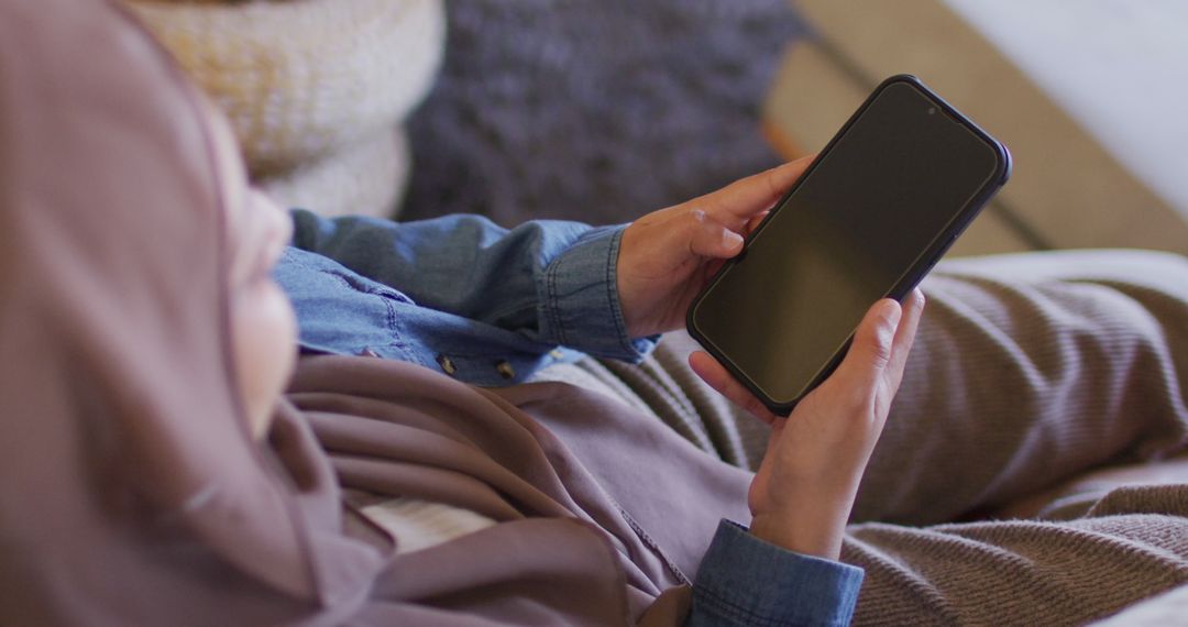 Close-up of Woman in Hijab Using Smartphone at Home - Free Images, Stock Photos and Pictures on Pikwizard.com