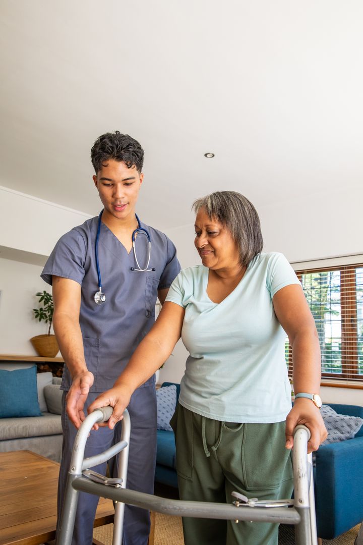 Supportive Healthcare Worker Assisting Elderly Woman at Home