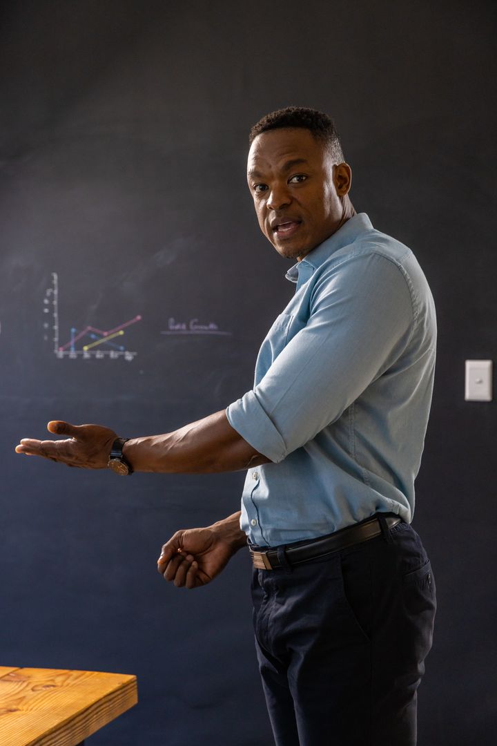 Business Professional Presenting Graph in Classroom Setting