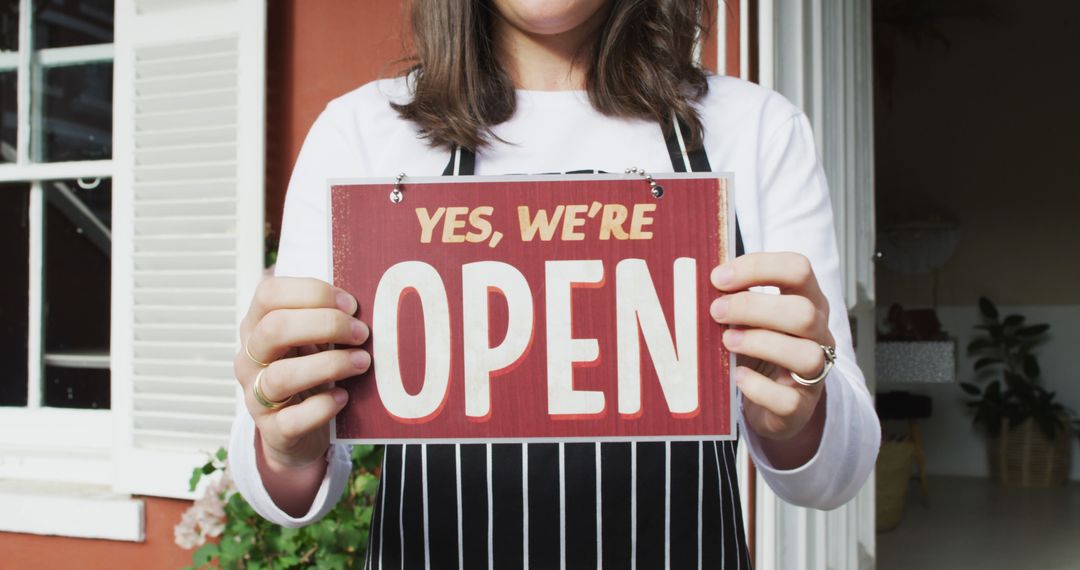 Waitress Holding Open Sign at Cafe Entrance
