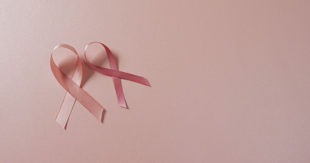 Image of two pink breast cancer ribbons on pale pink background - Free Images, Stock Photos and Pictures on Pikwizard.com