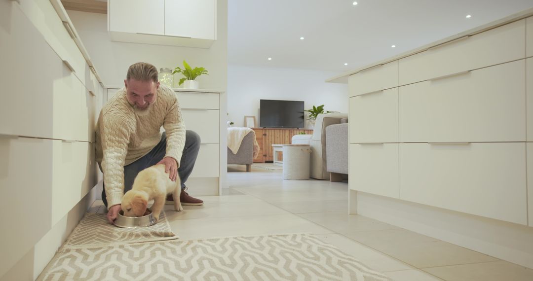 Man Feeding Labrador Puppy in Modern Minimalist Kitchen