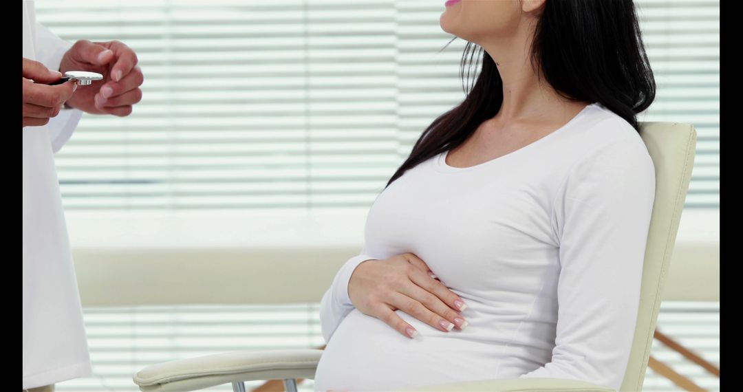 Pregnant woman consulting doctor in clinic - Free Images, Stock Photos and Pictures on Pikwizard.com