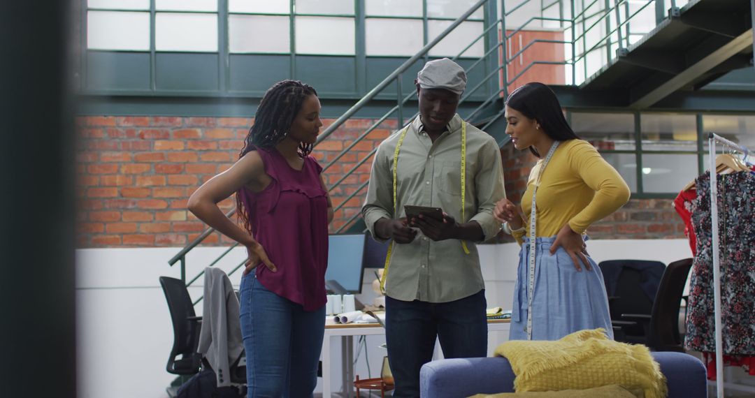 Fashion Designers Collaborating on New Designs in Modern Studio