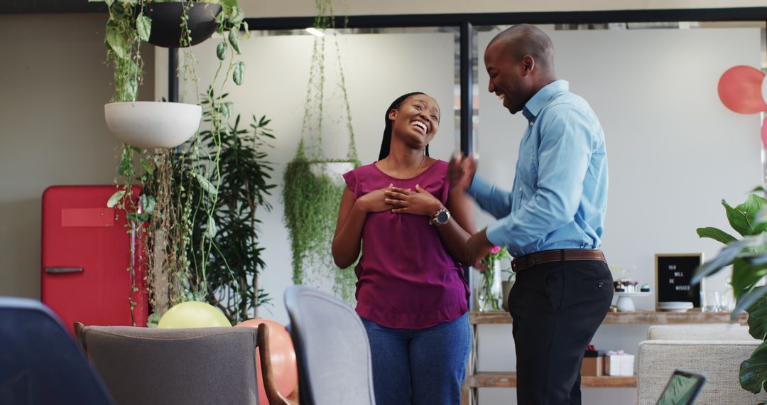 Colleagues Celebrating with Balloons at Office Party