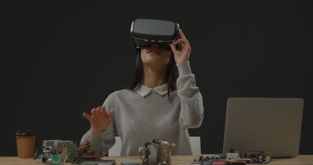 Woman Engaging with Virtual Reality and Technology at Office Desk - Free Images, Stock Photos and Pictures on Pikwizard.com