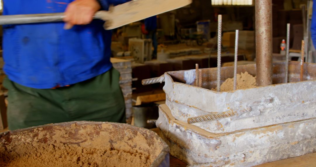 Worker putting soil in molds in foundry workshop - Free Images, Stock Photos and Pictures on Pikwizard.com