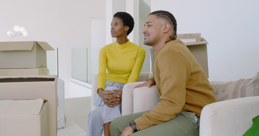 Couple Relaxing in Modern Living Room with Moving Boxes
