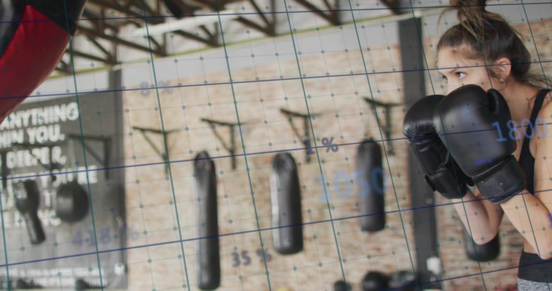 Woman Focused on Boxing Training in Industrial Gym Setting