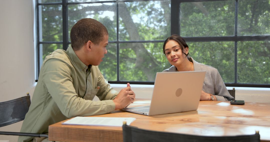 Colleagues Discuss Project Details in modern Office