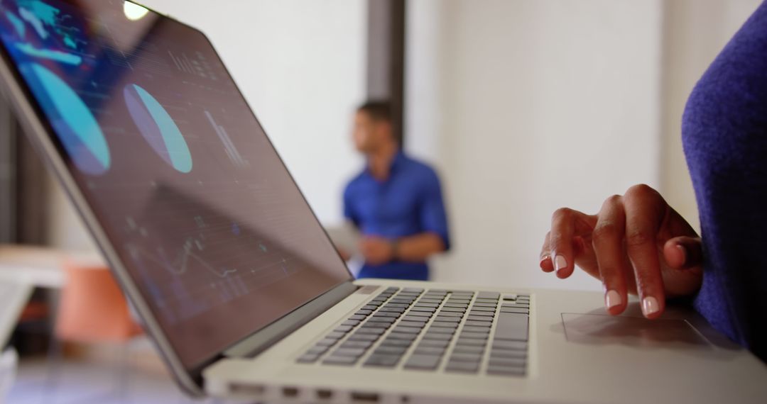 Close-up of Businesswoman Analyzing Data on Laptop in Office